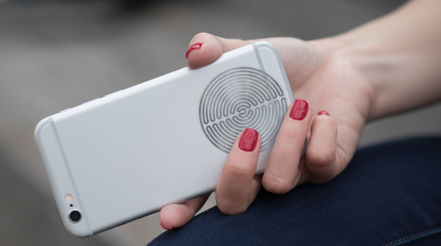 Gros plan d'un harmonisateur circulaire installé au dos d'un smartphone contemporain